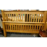 A modern oak double bed head and foot board, various slats, etc.(a quantity)