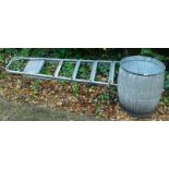 A galvanised metal dolly tub and a step ladder.