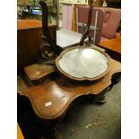 A Victorian mahogany veneered Duchess dressing table, the shaped mirror on pierced supports, the ser