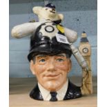 A Royal Doulton character jug, the London Bobby and a knitted bear in Police uniform.