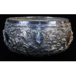 An early 20thC Indian ceremonial bowl, heavily repousse decorated with figures scrolls and