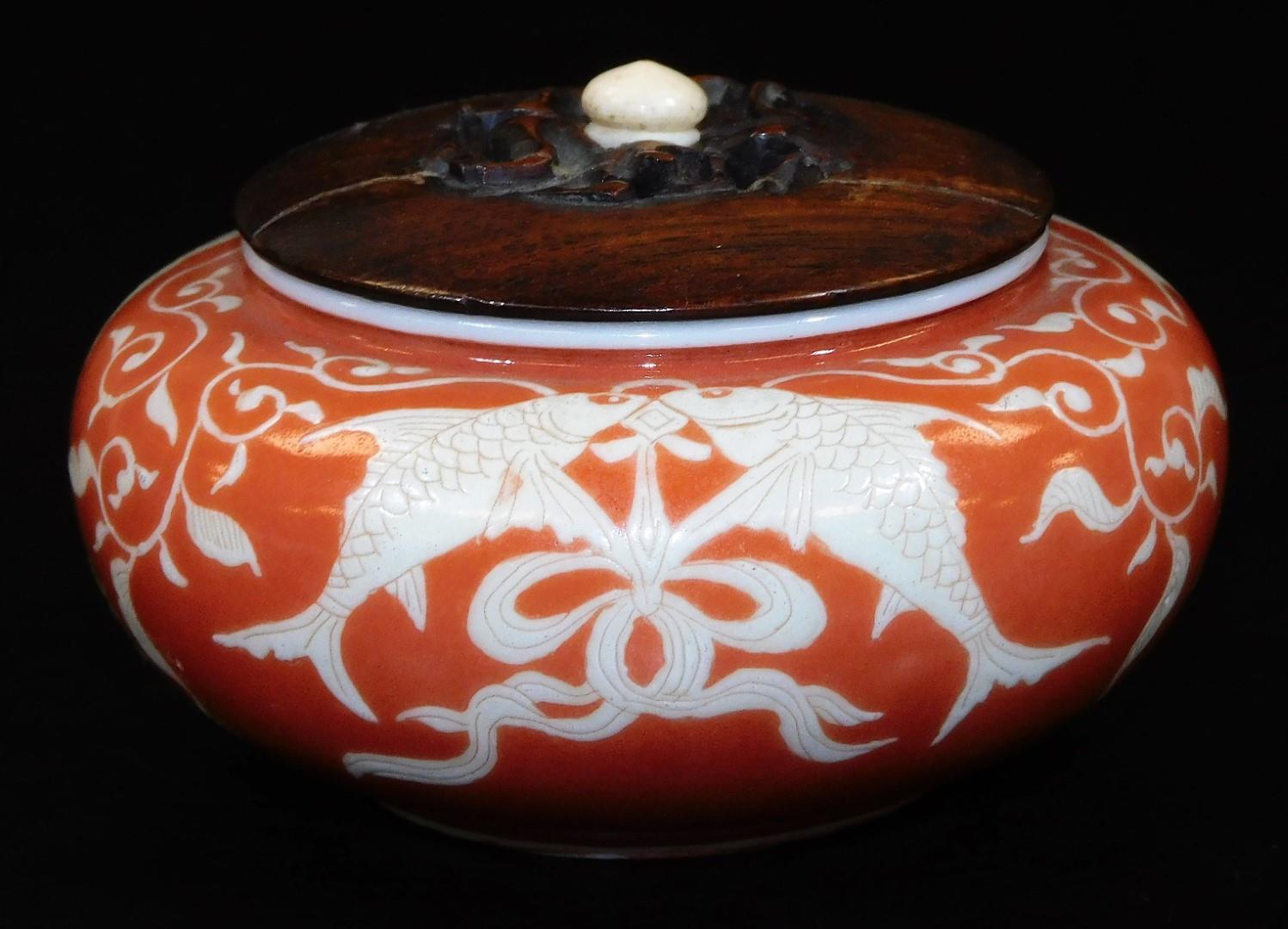 A Japanese porcelain koro, with original wood cover, decorated in coral and pale yellow enamel, with