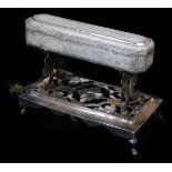 An early 20thC ceremonial freedom casket on stand, heavily chased with a repeat scroll floral