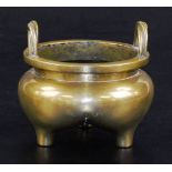 A Chinese bronze tripod censer, with bulbous body and twisted loop handles, six character Xuande