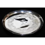An early 20thC Indian ceremonial dish, of circular form, with fin lip, decorated with a repeat
