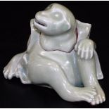 A Japanese celadon koro and cover, formed as a seated monkey with detachable head, signed to the