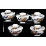 A set of five similar Japanese porcelain bowls and covers, decorated blue, peach and gold with