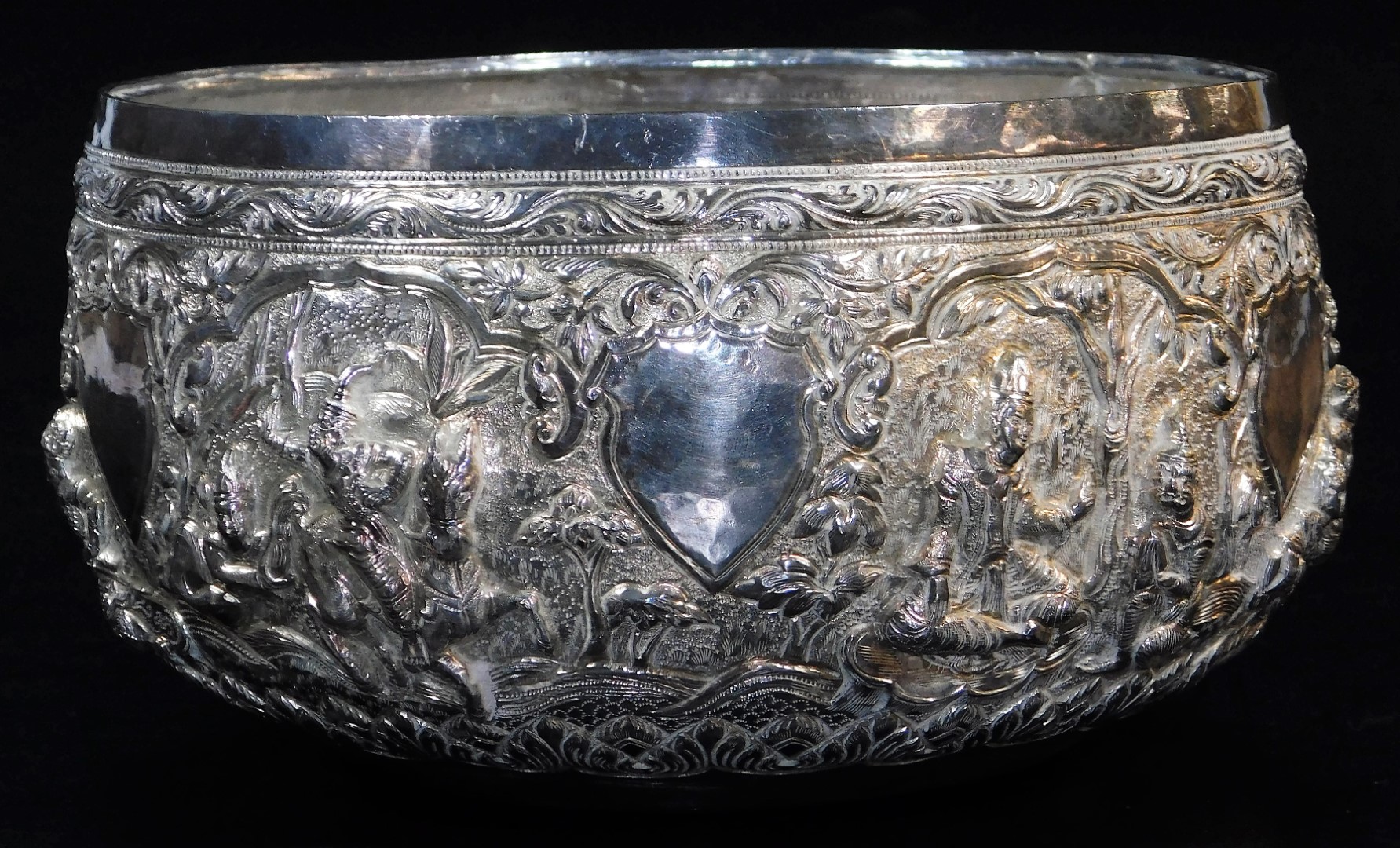 An early 20thC Indian ceremonial bowl, heavily repousse decorated with figures scrolls and - Image 2 of 8