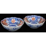 A pair of lobed Japanese porcelain Imari bowls, decorated in typical red, orange, green and