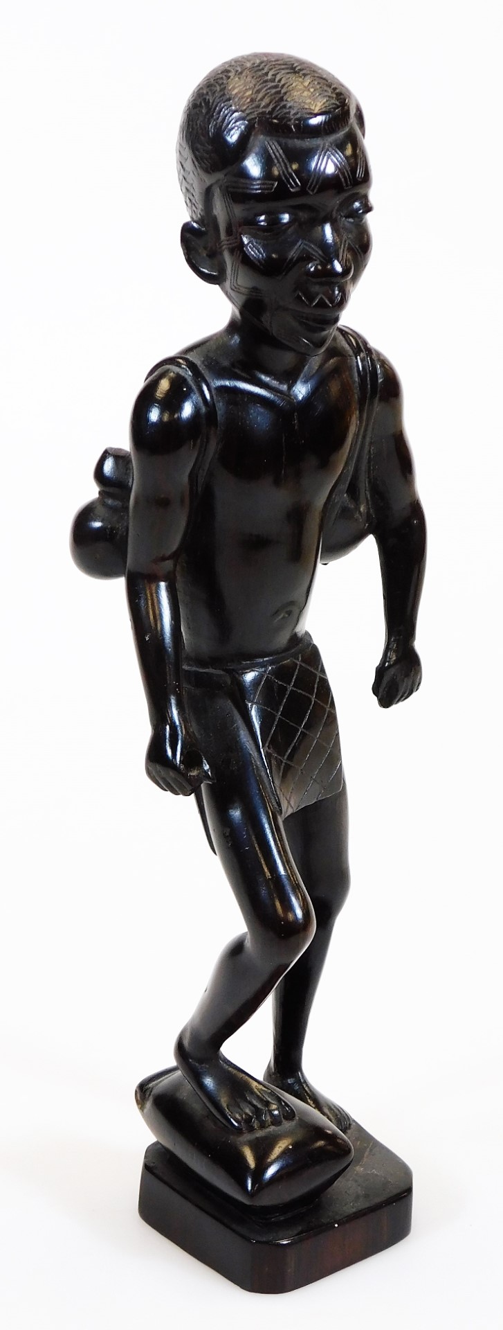 A heavily carved African tribal style figure, with foot raised on a canted base, unmarked, 32cm - Image 5 of 11