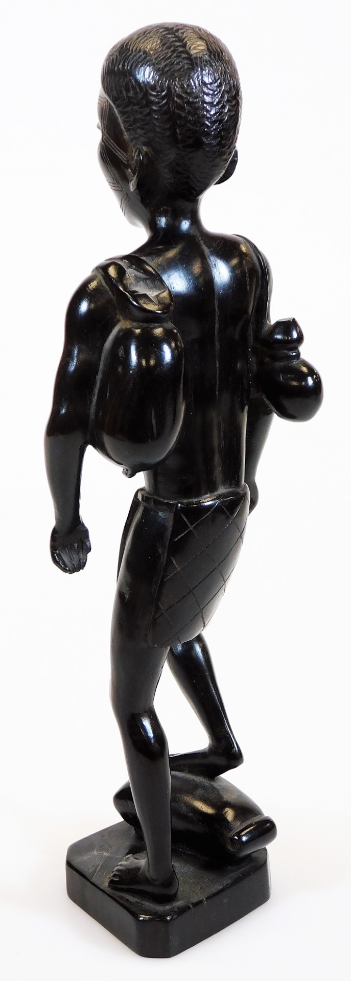 A heavily carved African tribal style figure, with foot raised on a canted base, unmarked, 32cm - Image 6 of 11