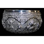 An early 20thC Indian ceremonial bowl, heavily repousse decorated with figures scrolls and