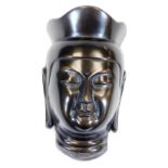 A metal wall mask, 25cm high.