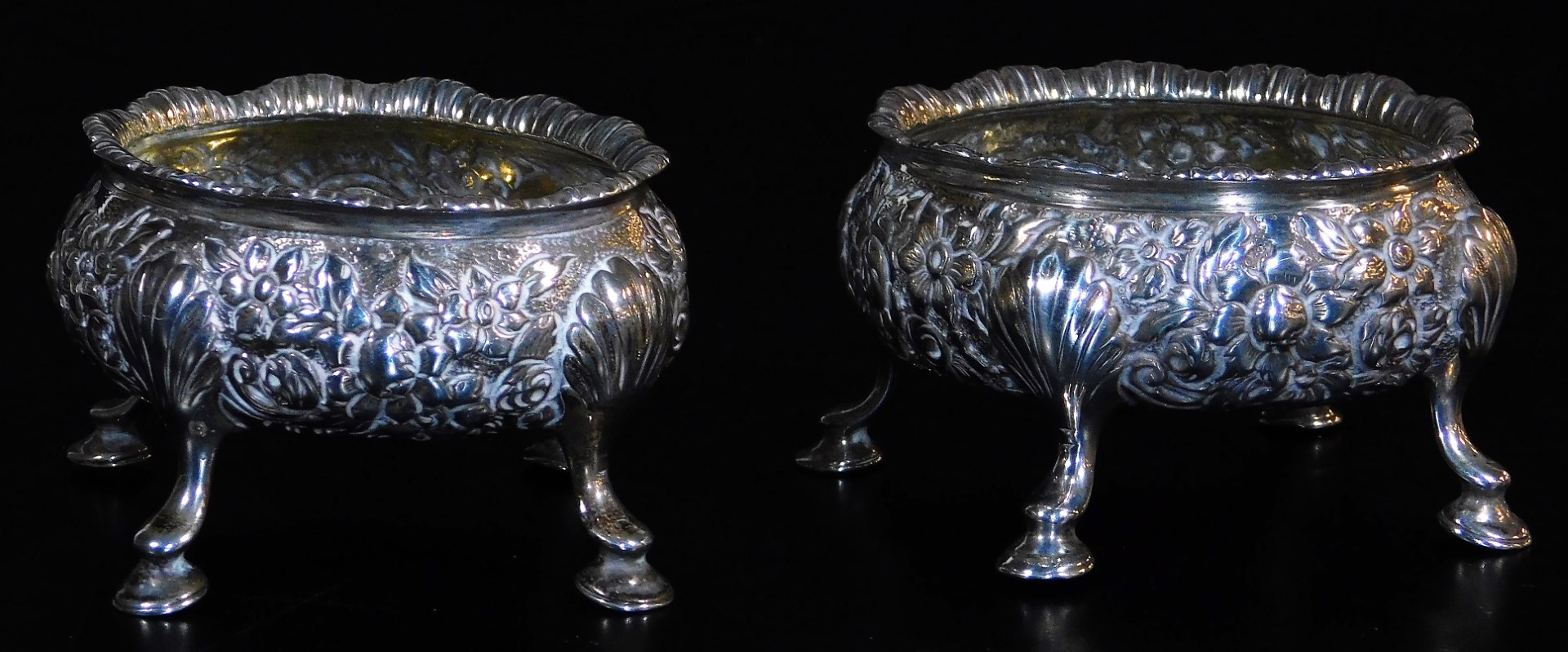 A pair of late 18thC silver salts, of oval form, heavily repousse decorated with a repeat floral - Image 2 of 3