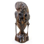 A heavily carved African tribal tiger wood head, with elaborate floral headdress, unsigned, 33cm