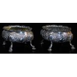 A pair of late 18thC silver salts, of oval form, heavily repousse decorated with a repeat floral