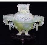 A Chinese green hard stone censer with pierced cover, set with rings and scrolls and flowers, the
