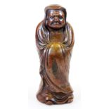 A Japanese Bizen figure of the Buddhist monk Daruma in standing pose, Meiji period, 25.8cm high.