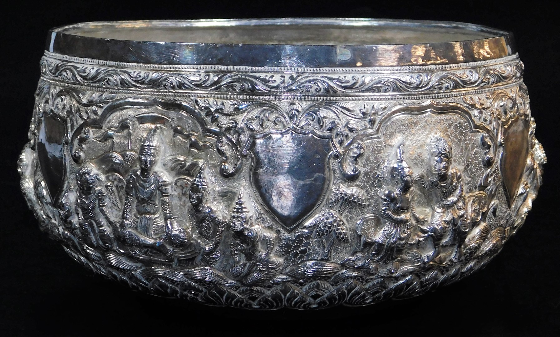 An early 20thC Indian ceremonial bowl, heavily repousse decorated with figures scrolls and - Image 3 of 8