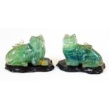 A pair of Chinese carved green quartz figures of felines, each on wood base, 19th/20thC, 8cm high.