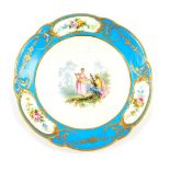 A Sevres style 19thC bleu celeste plate, painted centrally with a seated musician and a dancer in