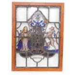 A stained glass window panel, pine framed, bearing the Coat of Arms and Motto of the City of