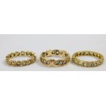 Three 9ct gold and white sapphire set full eternity rings, two stones lacking, two size J, one