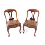 A pair of Victorian mahogany spoon back dining chairs, with studded leather seats, and cabriole