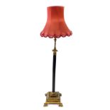 A brass and painted reeded column standard lamp, with rise and fall mechanism, and oil lamp