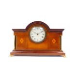 An Edwardian mahogany and inlaid mantel clock, circular dial bearing Roman numerals, clockwork