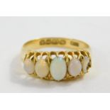 An 18ct gold and opal five stone ring, claw set, size N, 2.9g.