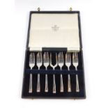 A George VI silver cake set, comprising six cake forks and a serving fork, cased, Sheffield 1946,