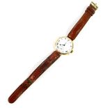 A 9ct gold wristwatch, circa 1915, circular cased, white enamel dial bearing Roman numerals,