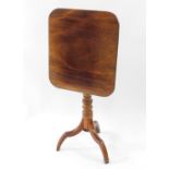 A Victorian mahogany tripod table, with rounded rectangular folding top and turned pillar.