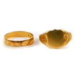 A lady's 18ct gold shield shaped signet ring, with embossed floral decoration, size M, together with