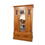A Victorian satin walnut single wardrobe, with mirror door, and drawer base, 123cm wide.