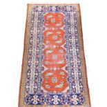 A Caucasian light brown ground rug, decorated with four central fields, with floral and floriate