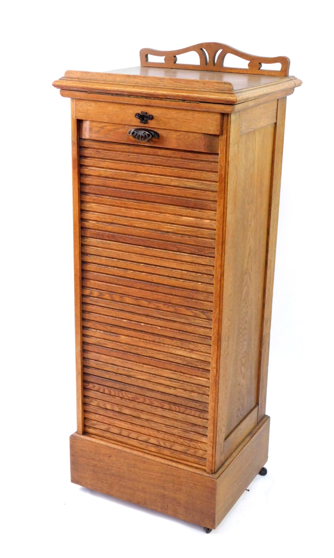 A Victorian oak tambour fronted clerk's desk, with a hinged lectern top, over nine sliding trays,