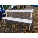 A Coalbrookdale style white painted garden bench, with rustic branch ends, 182cm wide, 58cm deep.
