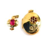 A 9ct gold and garnet set oval photo locket, the front floral decorated, together with a 9ct gold