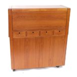 A d-SCAN teak side cabinet, with fall flap top, over four drawers and two door cupboard base,