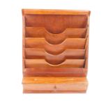 A 1950's hardwood desk organiser, with a waterfall five tier stationery rack, pen recess and