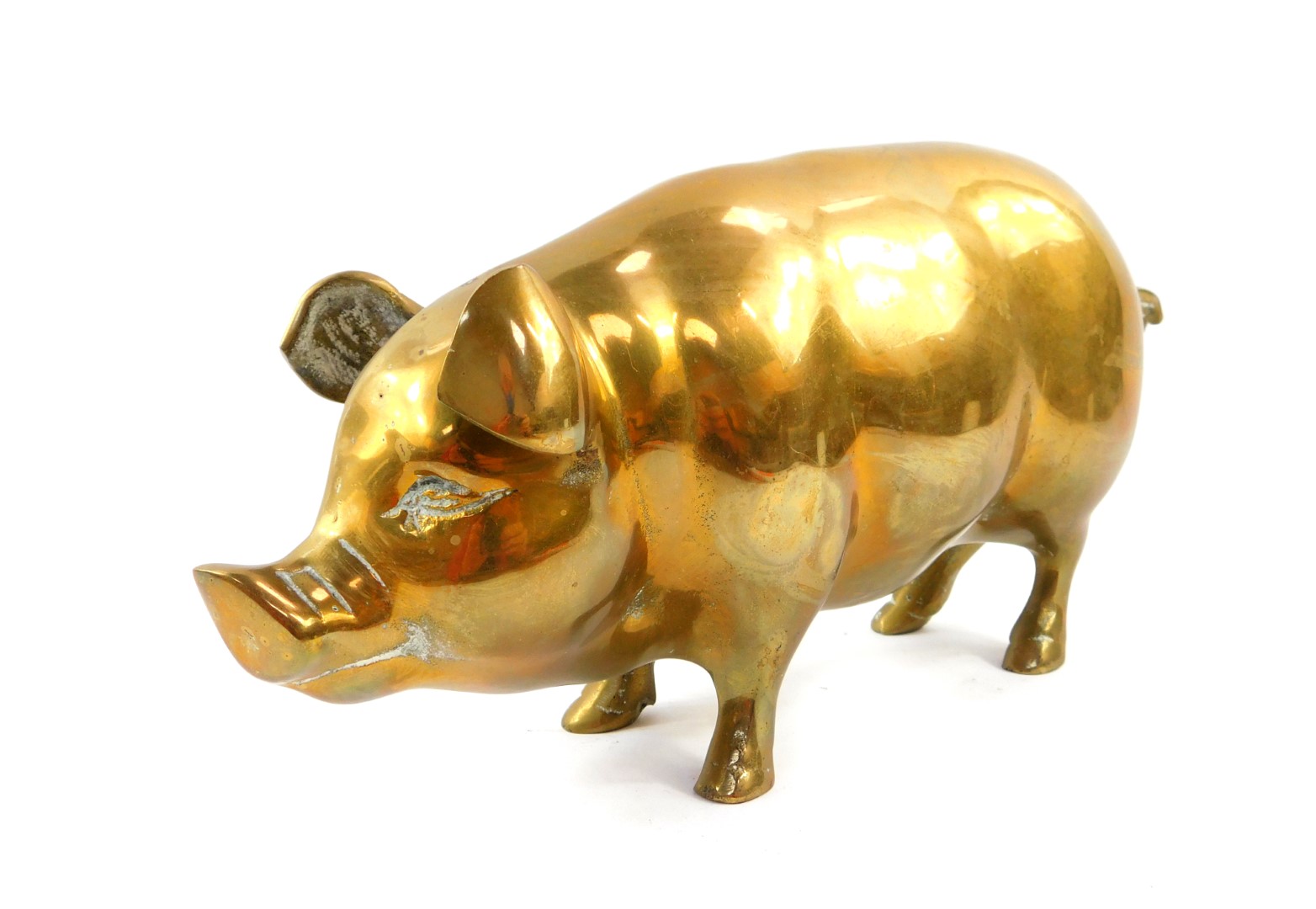 A brass figure of a pig, 29cm wide.