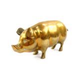 A brass figure of a pig, 29cm wide.