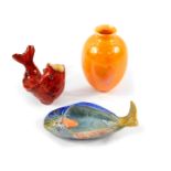 A Moore Bros red glazed pottery figure of a fish, with glass eyes, 9.5cm wide., Beswick fish dish,