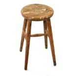 A late 19thC stripped pine stool, with circular seat, 47cm high.