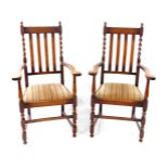 A pair of 1920's barleytwist oak carver chairs, with drop-in seats.