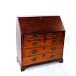 A George III mahogany bureau, with fall flap resting on lopers enclosing fitted interior, over two