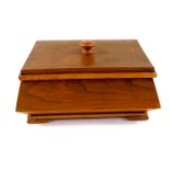 An Art Deco oak sewing box, of casket form, the lid opening to reveal an interior with single