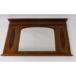 An Edwardian mahogany and flame mahogany over mantle mirror, the central section inset with domed